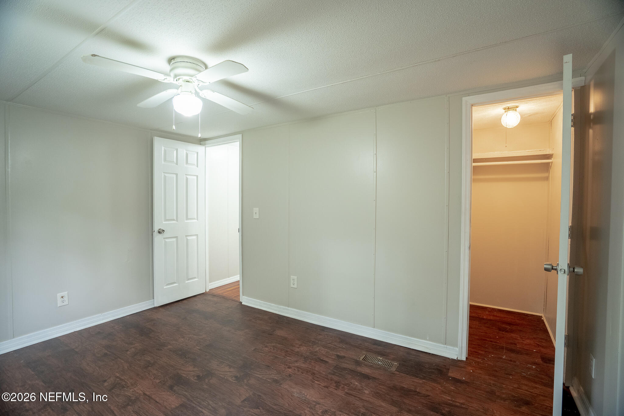 3180 Pacetti Road, Unit A St. Augustine, FL 32092 - Photo 10 of 23 an empty room with wooden floor closet and fan