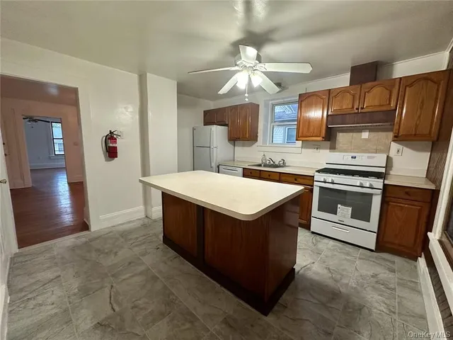 a kitchen with stainless steel appliances granite countertop a stove and a sink
