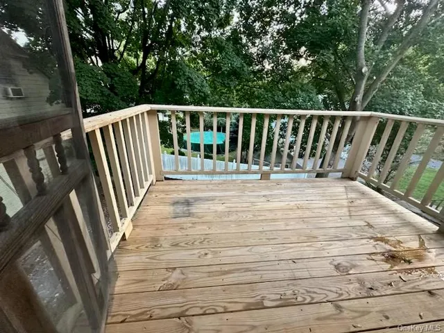 a view of balcony with wooden floor and fence