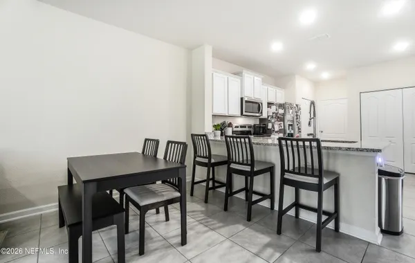 a kitchen with stainless steel appliances granite countertop a refrigerator and a stove