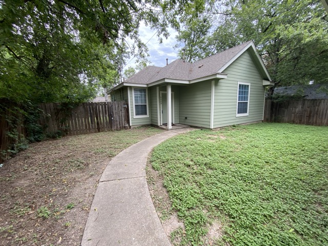 504 West N Loop Boulevard, Unit B Austin, TX 78751 - Photo 1 of 1 a front view of a house with a garden and trees