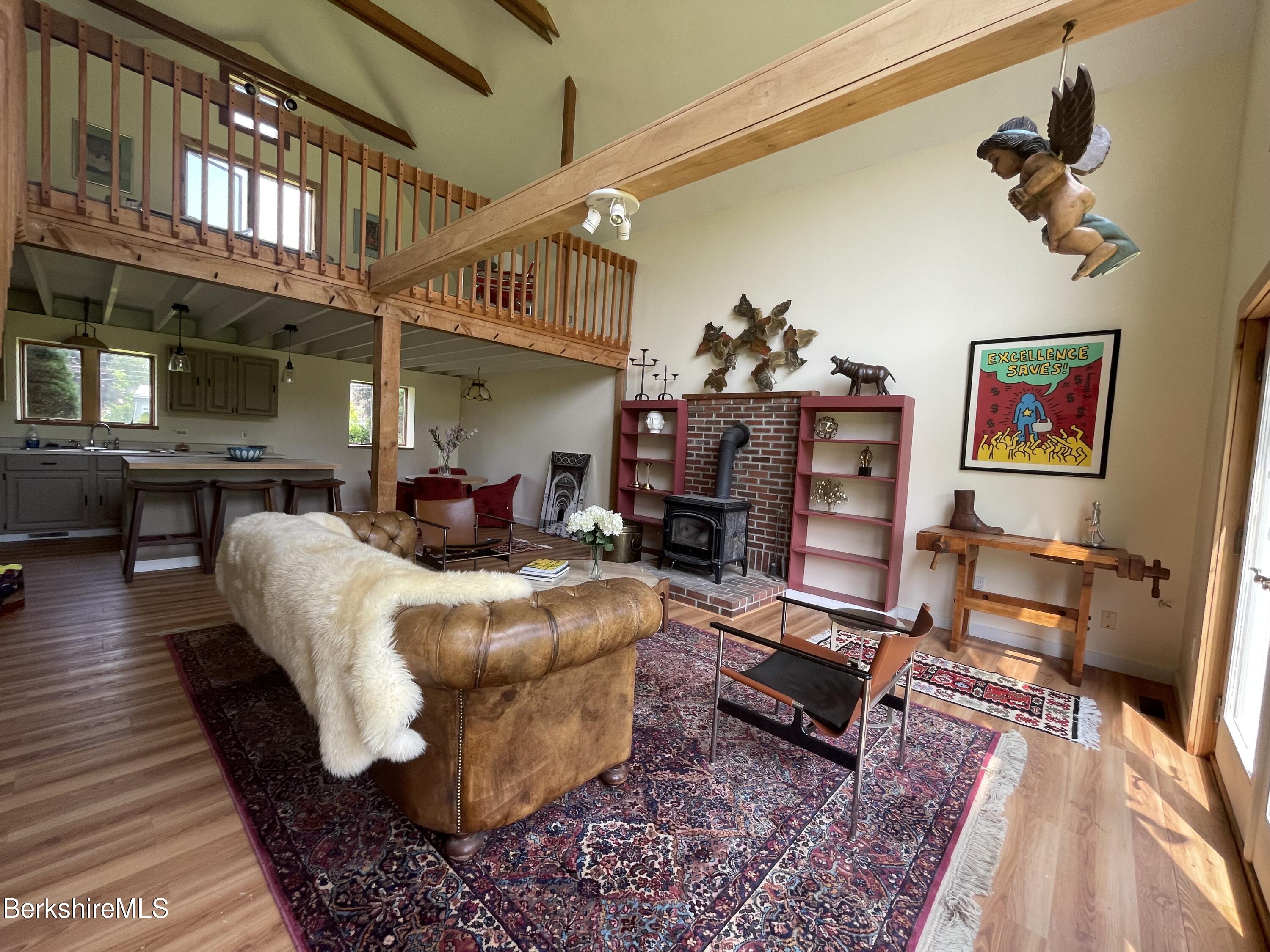 259 Salisbury Road Sheffield, MA 01257 - Photo 20 of 51 a living room with furniture rug and a floor to ceiling window