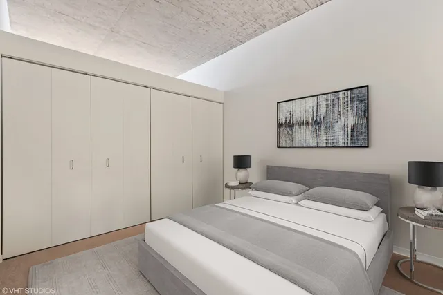 a bedroom with a bed and a painting on the wall