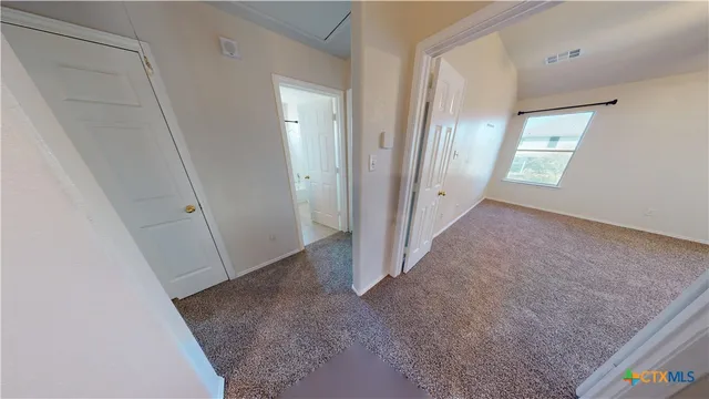 a view of a hallway to rooms