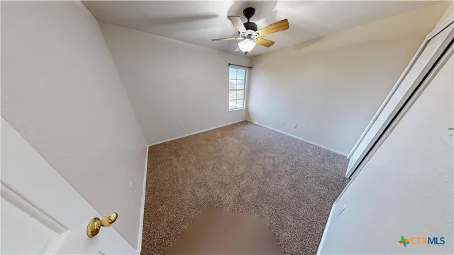 a view of an empty room and a window