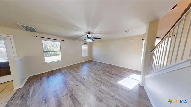 wooden floor in an empty room with a window