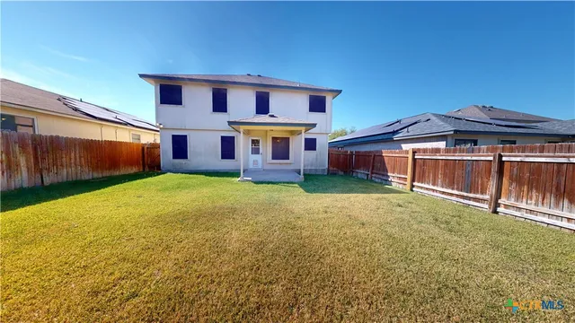 a front view of a house with a garden and yard