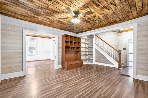 a view of empty room with wooden floor
