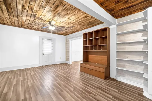 a view of wooden floor and entryway in a room
