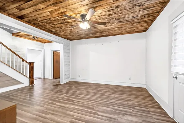 a view of an empty room with wooden floor