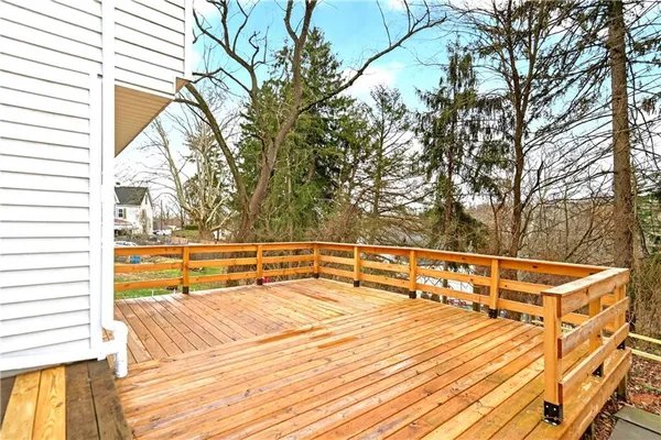 a view of a tennis court with trees in the background