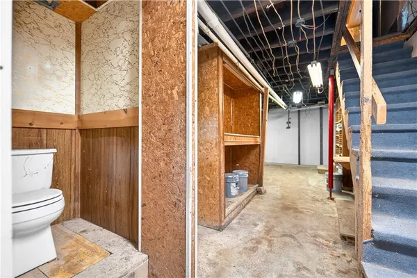 a bathroom with a toilet and a shower