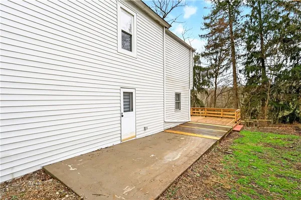 a front view of a house with a yard covered in snow