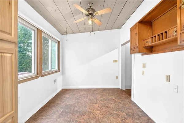 a view of a livingroom with a ceiling fan and window