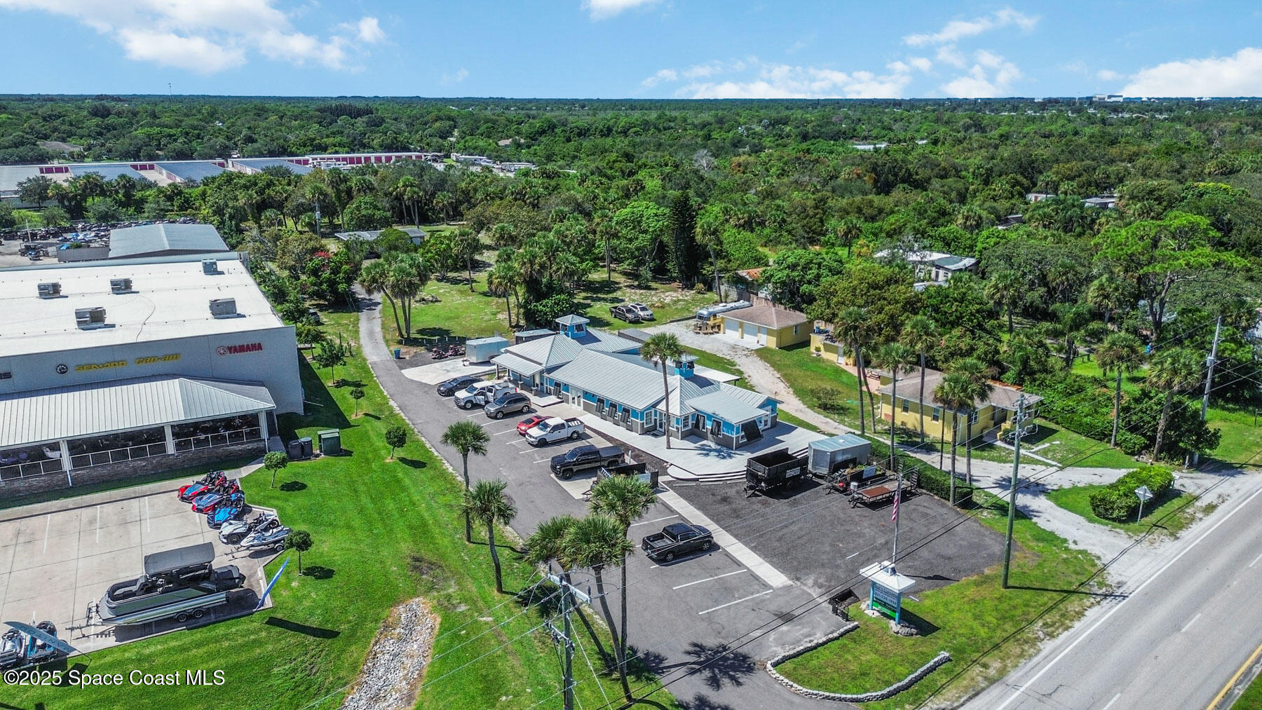 an aerial view of multiple houses with yard