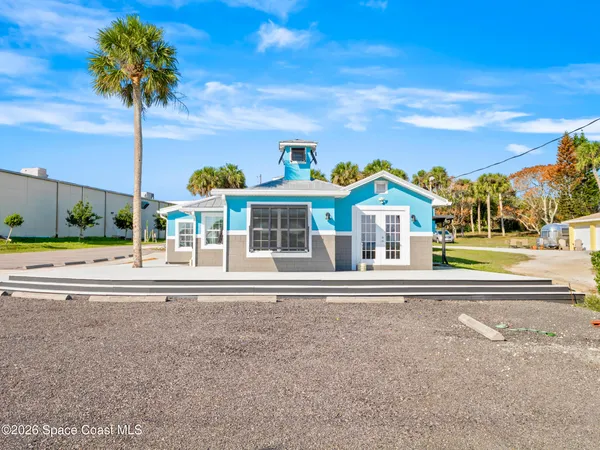 a brick wall with a yard in the back