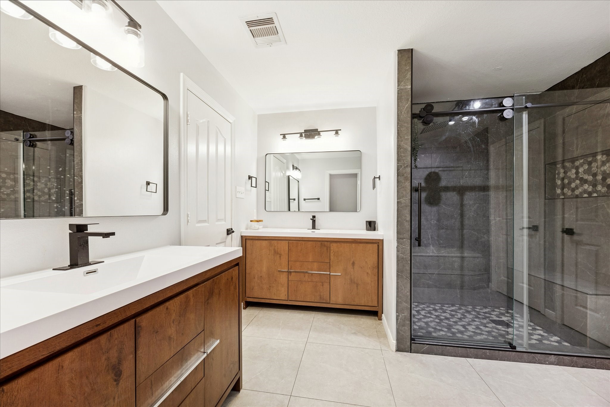 6426 East Linpar Court Houston, TX 77040 - Photo 14 of 23 a bathroom with a double vanity sink mirror and shower