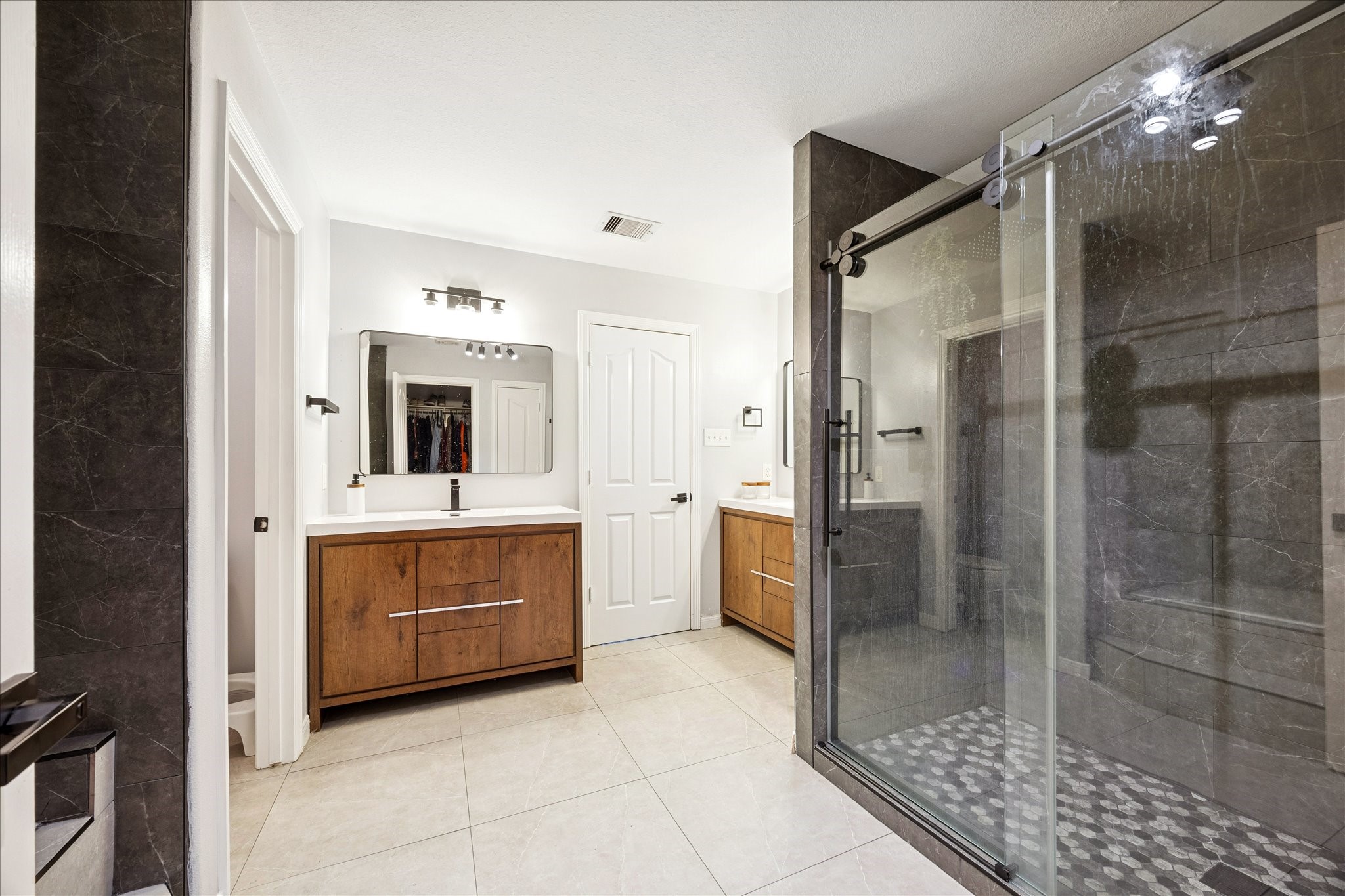 6426 East Linpar Court Houston, TX 77040 - Photo 15 of 23 a bathroom with a shower sink and mirror