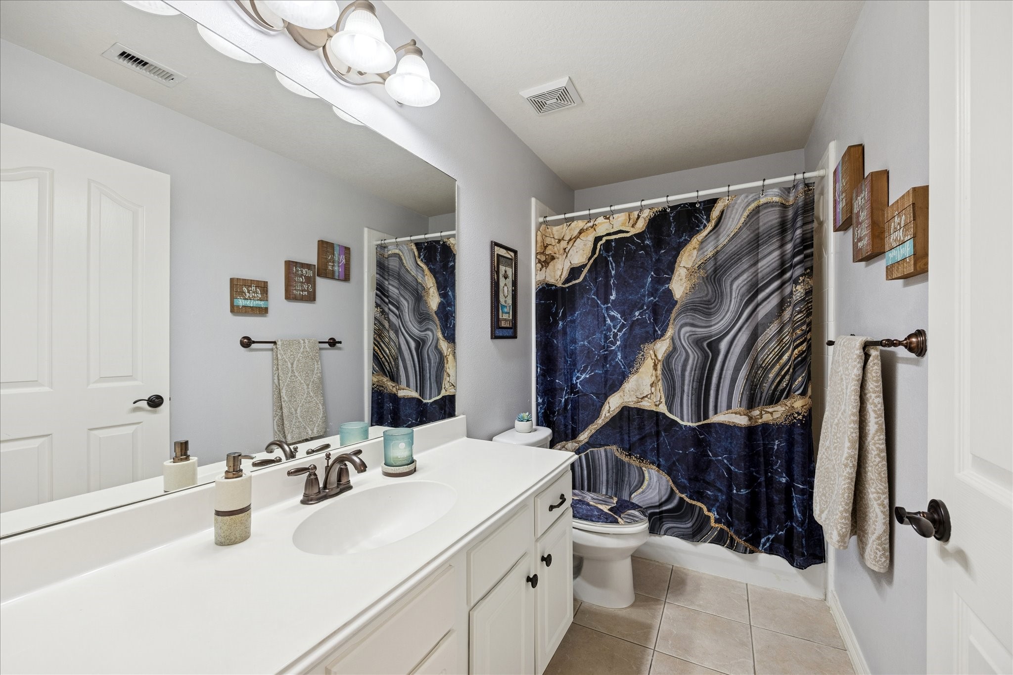 6426 East Linpar Court Houston, TX 77040 - Photo 18 of 23 a bathroom with a double vanity sink mirror and shower