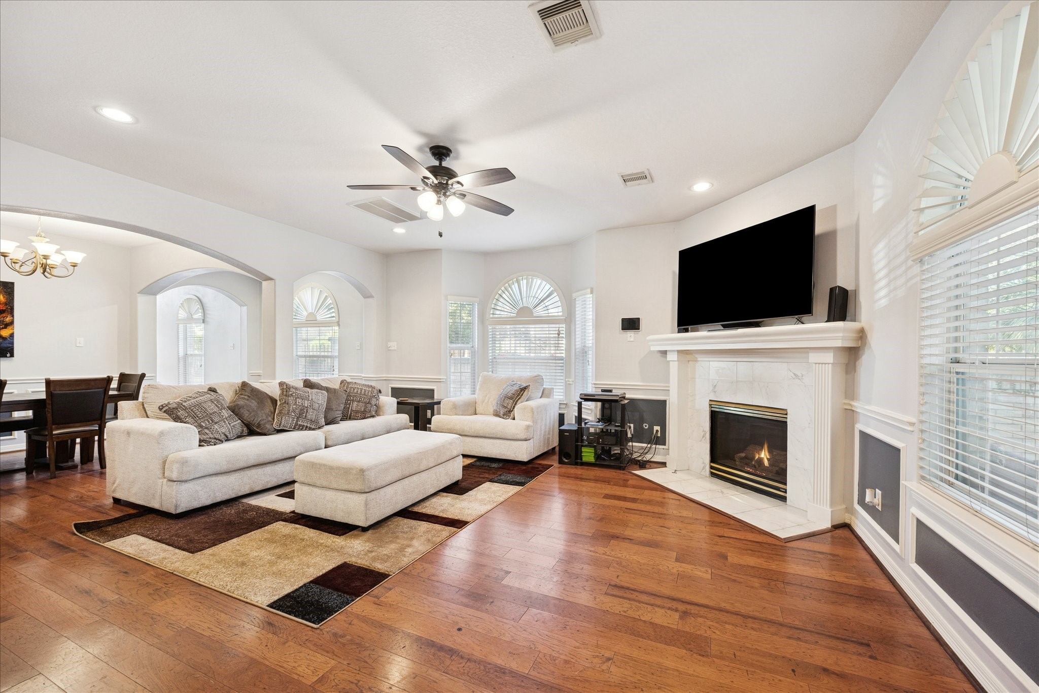 6426 East Linpar Court Houston, TX 77040 - Photo 2 of 23 a living room with furniture a fireplace and a flat screen tv
