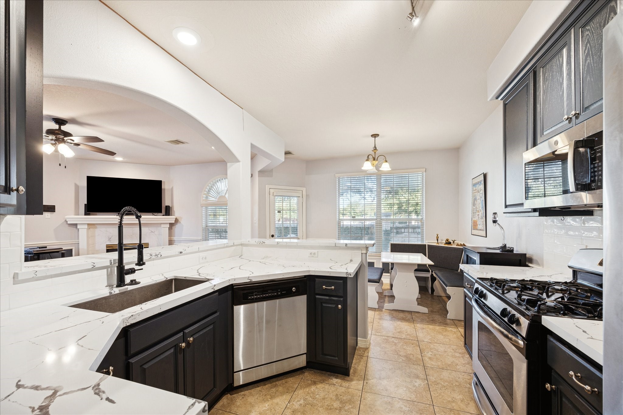 6426 East Linpar Court Houston, TX 77040 - Photo 3 of 23 a kitchen with stainless steel appliances granite countertop a sink and a stove