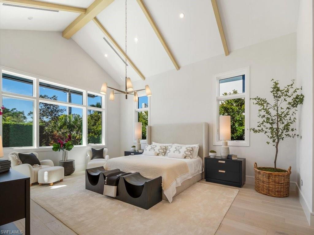 612 Binnacle Drive Naples, FL 34103 - Photo 29 of 50 Bedroom with high vaulted ceiling, a chandelier, baseboards, wood finished floors, and beam ceiling