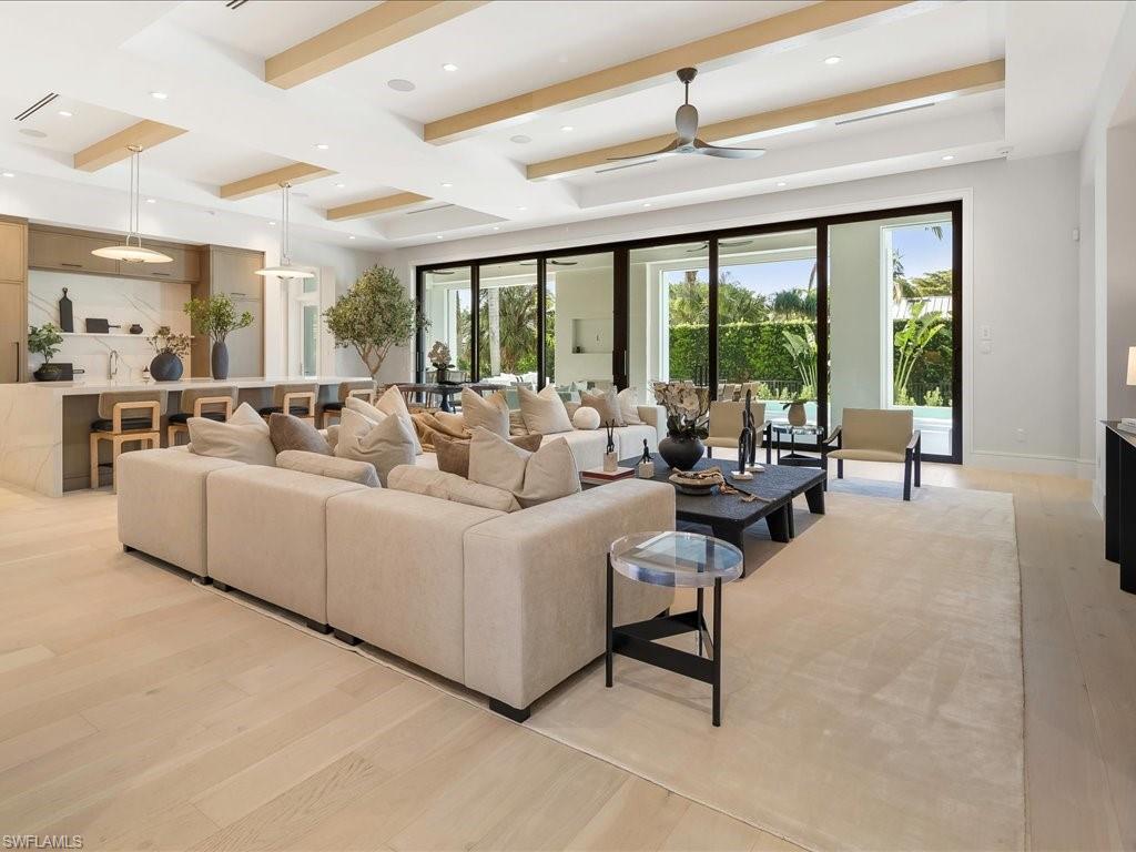612 Binnacle Drive Naples, FL 34103 - Photo 3 of 50 Living area with beamed ceiling, baseboards, recessed lighting, a ceiling fan, and light wood-type flooring