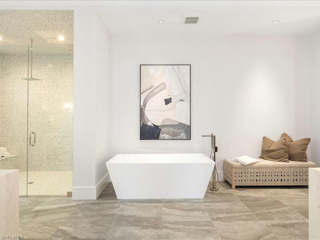 612 Binnacle Drive Naples, FL 34103 - Photo 30 of 50 Bathroom with baseboards, a soaking tub, marble finish floor, a stall shower, and visible vents