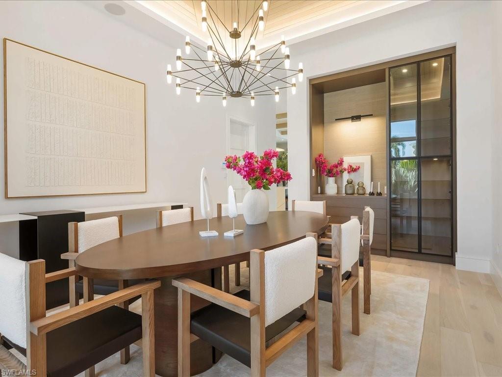 612 Binnacle Drive Naples, FL 34103 - Photo 9 of 50 Dining area with a notable chandelier and light wood-style floors