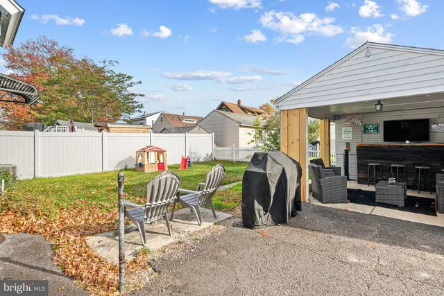 a view of a patio with table and chairs and potted plants