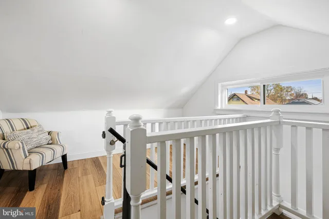 a view of a livingroom with furniture and staircase