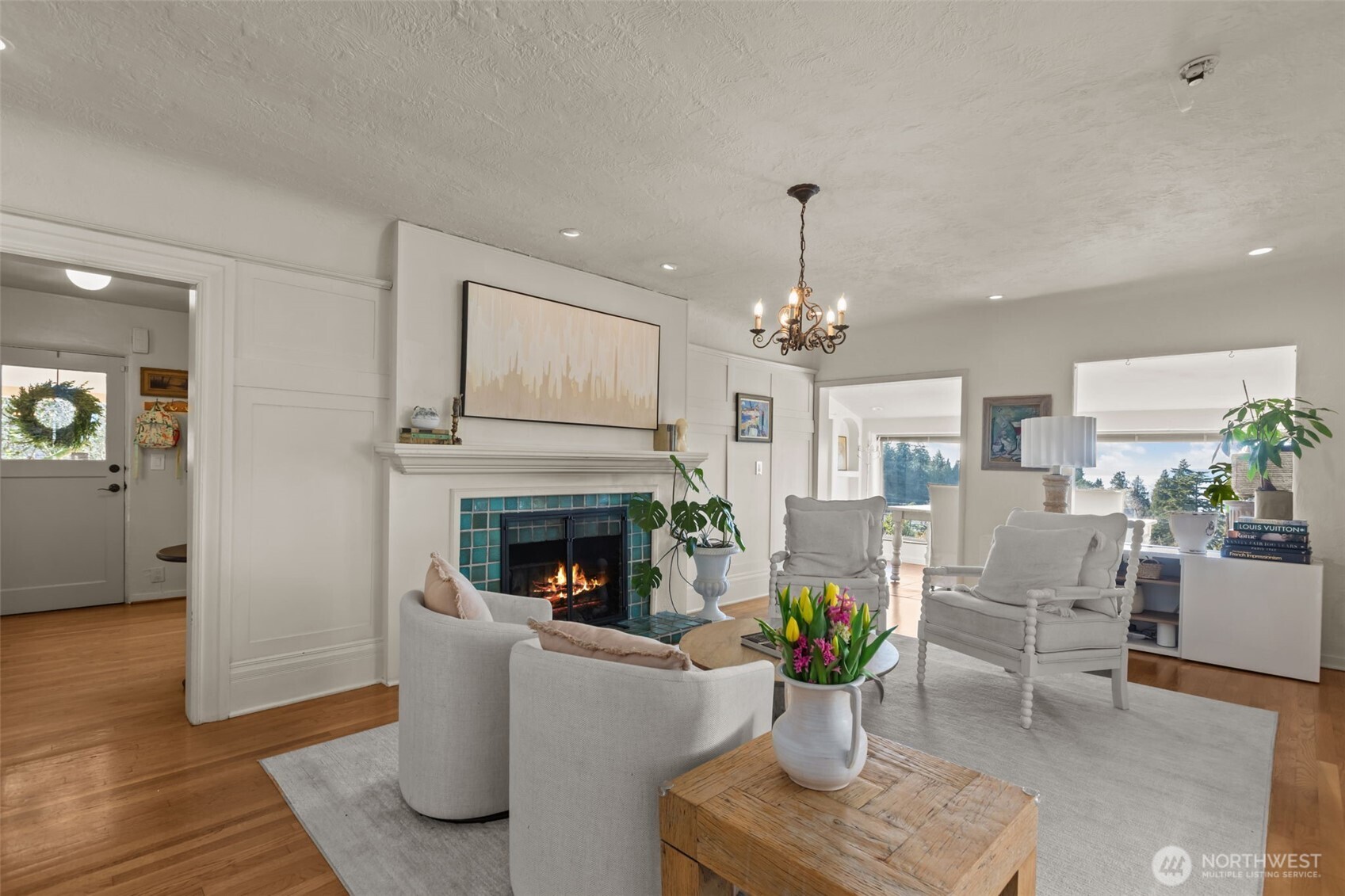 4411 Southwest Othello Street Seattle, WA 98136 - Photo 8 of 36 a living room with furniture a fireplace and a chandelier