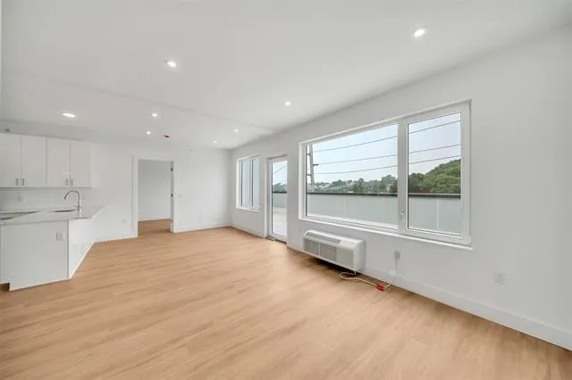 a view of an empty room with a window