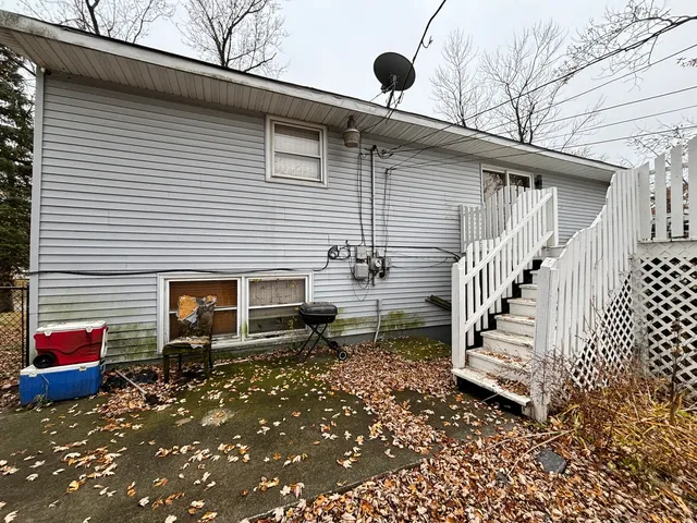 a view of a house with a yard and furniture
