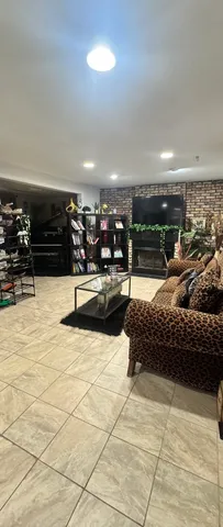 a living room with lots of furniture and gym equipment