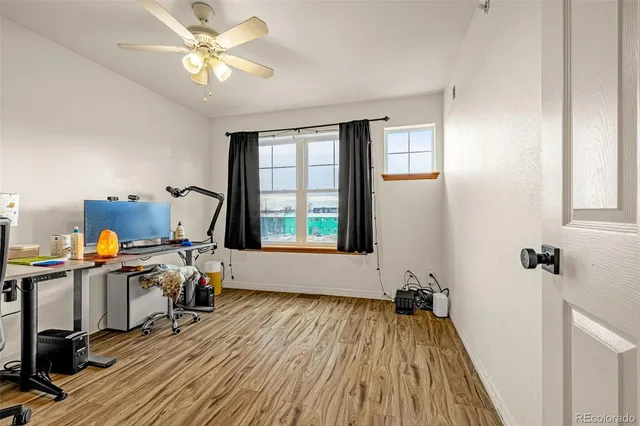 a view of a workspace with furniture and a window