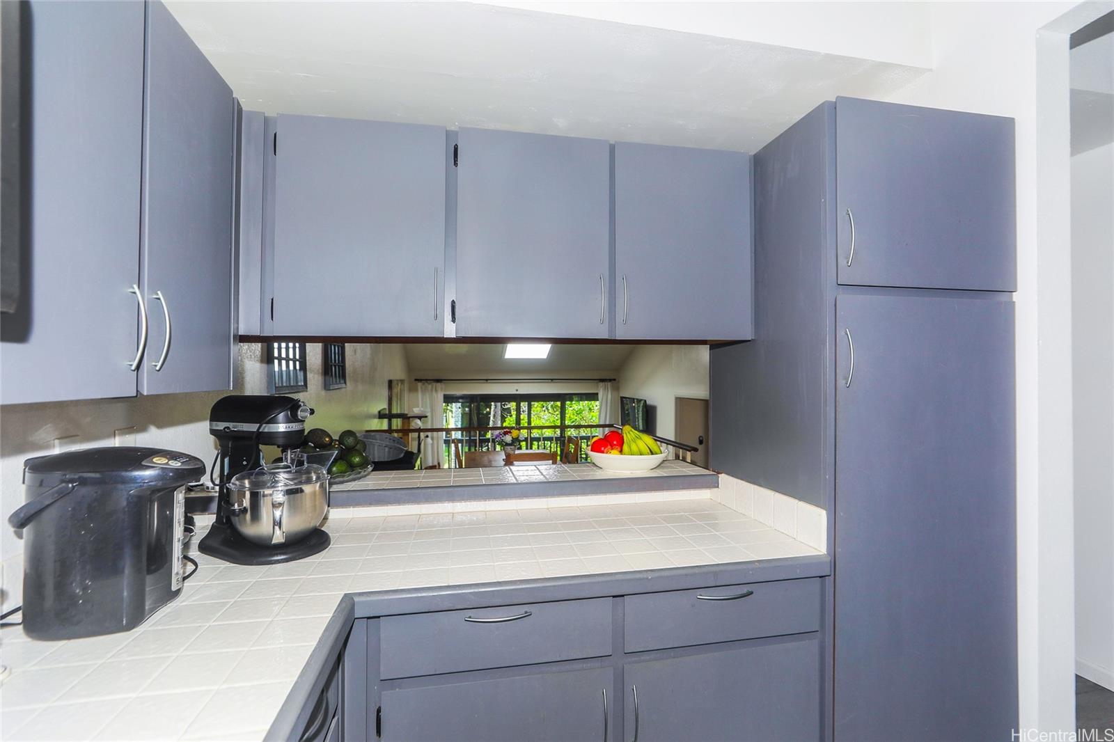 45-995 Wailele Road, Unit 8 Kaneohe, HI 96744 - Photo 14 of 25 A nicely sized kitchen has a see through view of the living area & stream.