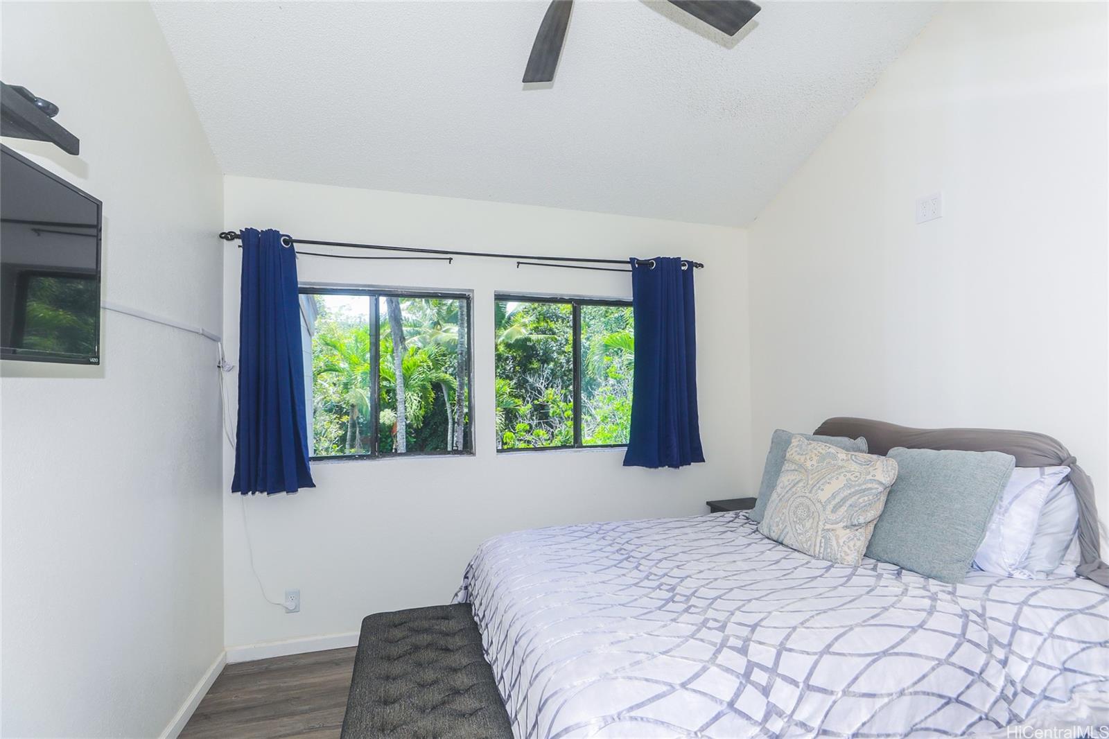 45-995 Wailele Road, Unit 8 Kaneohe, HI 96744 - Photo 17 of 25 Primary bedroom has vaulted ceilings and overlooks the stream