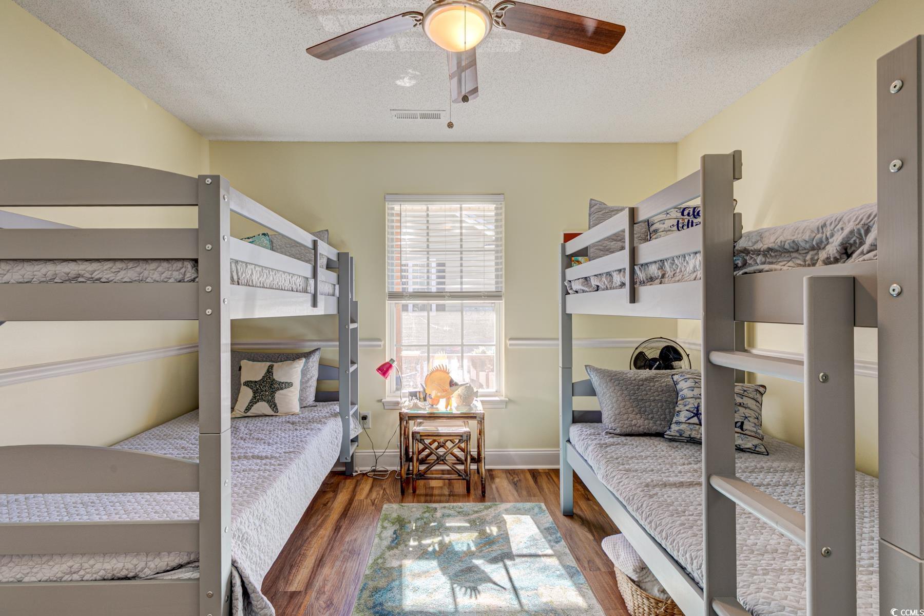 4840 Moss Creek Loop, Unit 36 Murrells Inlet, SC 29576 - Photo 11 of 37 Bedroom with wood finished floors, a textured ceiling, and ceiling fan