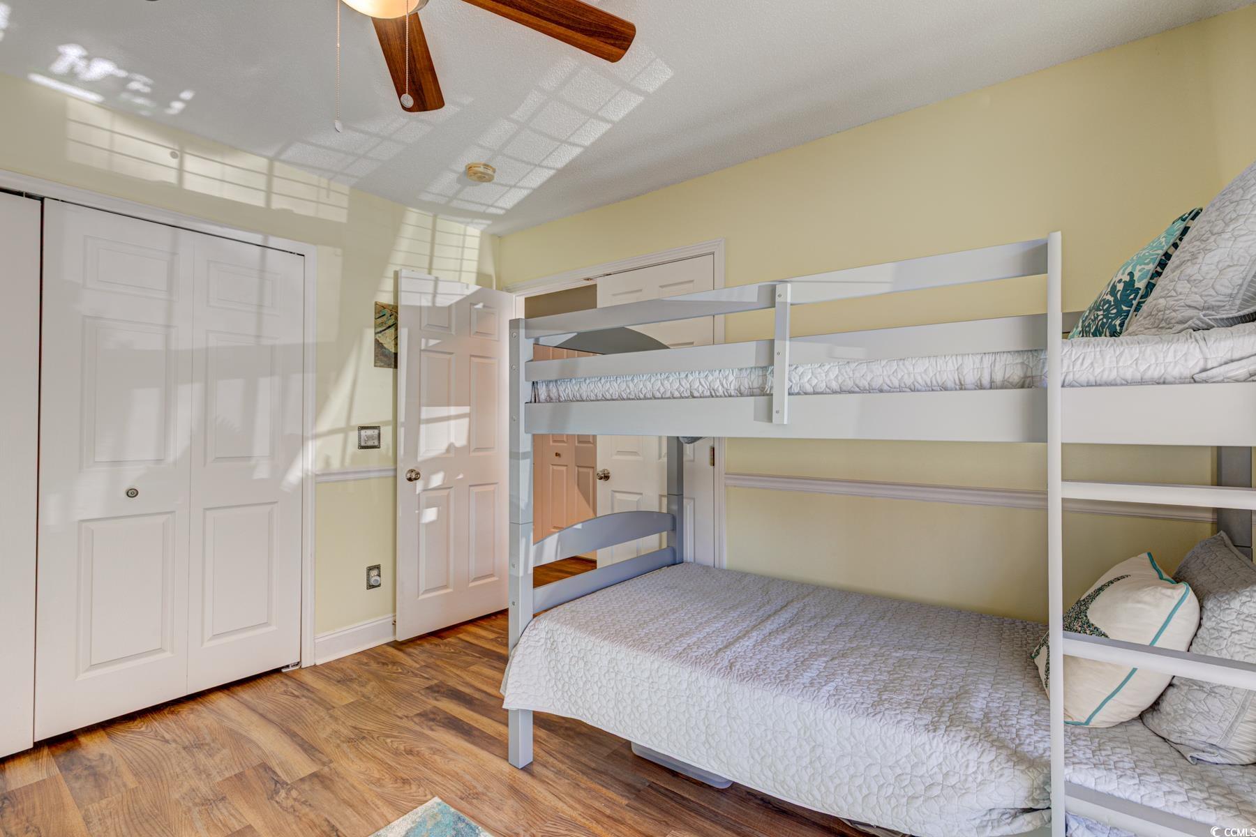 4840 Moss Creek Loop, Unit 36 Murrells Inlet, SC 29576 - Photo 12 of 37 Bedroom featuring wood finished floors, a closet, and ceiling fan