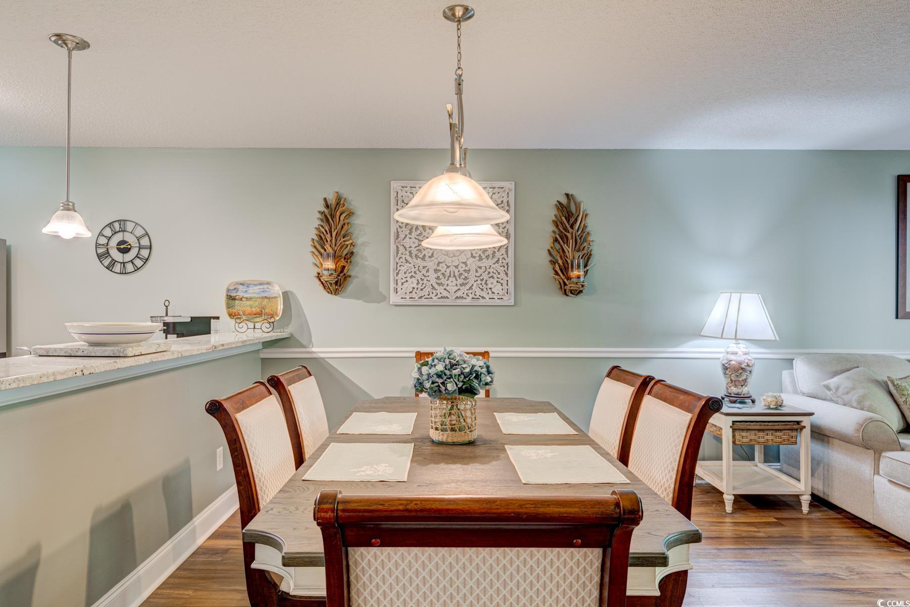 4840 Moss Creek Loop, Unit 36 Murrells Inlet, SC 29576 - Photo 16 of 37 Dining area featuring dark wood-style floors and a textured ceiling