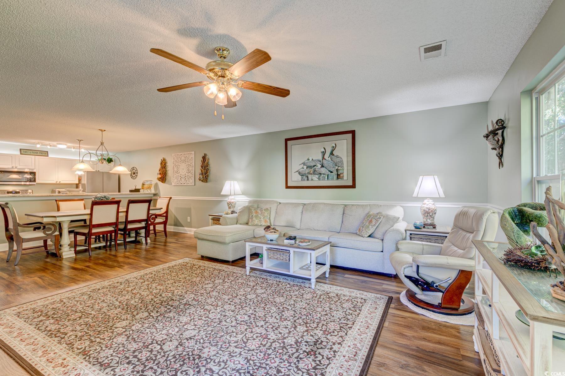 4840 Moss Creek Loop, Unit 36 Murrells Inlet, SC 29576 - Photo 18 of 37 Living room featuring wood finished floors, a textured ceiling, and ceiling fan