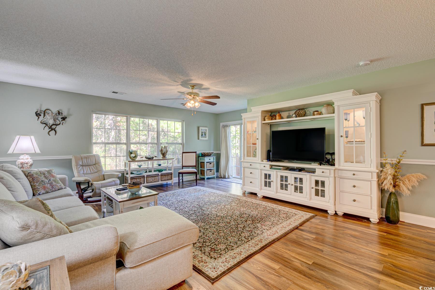 4840 Moss Creek Loop, Unit 36 Murrells Inlet, SC 29576 - Photo 19 of 37 Living area with light wood finished floors, a textured ceiling, and a ceiling fan