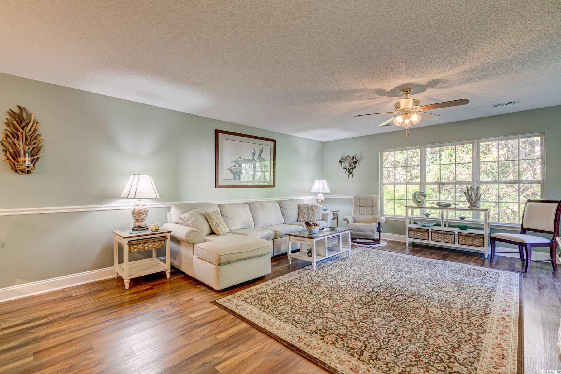 4840 Moss Creek Loop, Unit 36 Murrells Inlet, SC 29576 - Photo 20 of 37 Living area featuring dark wood-style floors, a textured ceiling, and ceiling fan