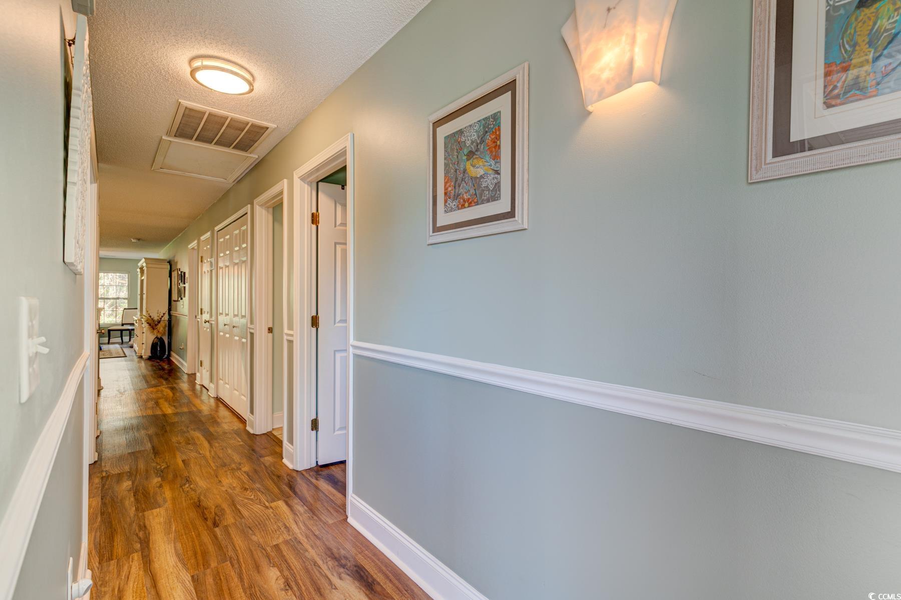 4840 Moss Creek Loop, Unit 36 Murrells Inlet, SC 29576 - Photo 2 of 37 Hallway with a textured ceiling and dark wood-style floors