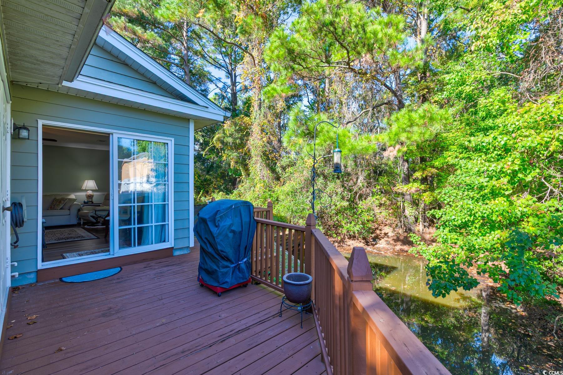 4840 Moss Creek Loop, Unit 36 Murrells Inlet, SC 29576 - Photo 31 of 37 Wooden terrace with a grill and view of wooded area
