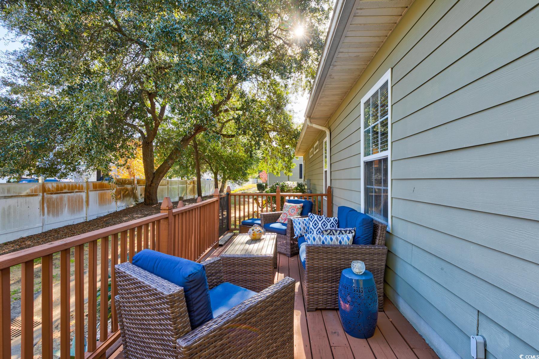 4840 Moss Creek Loop, Unit 36 Murrells Inlet, SC 29576 - Photo 33 of 37 Wooden terrace featuring an outdoor hangout area, a fenced backyard, and a water view