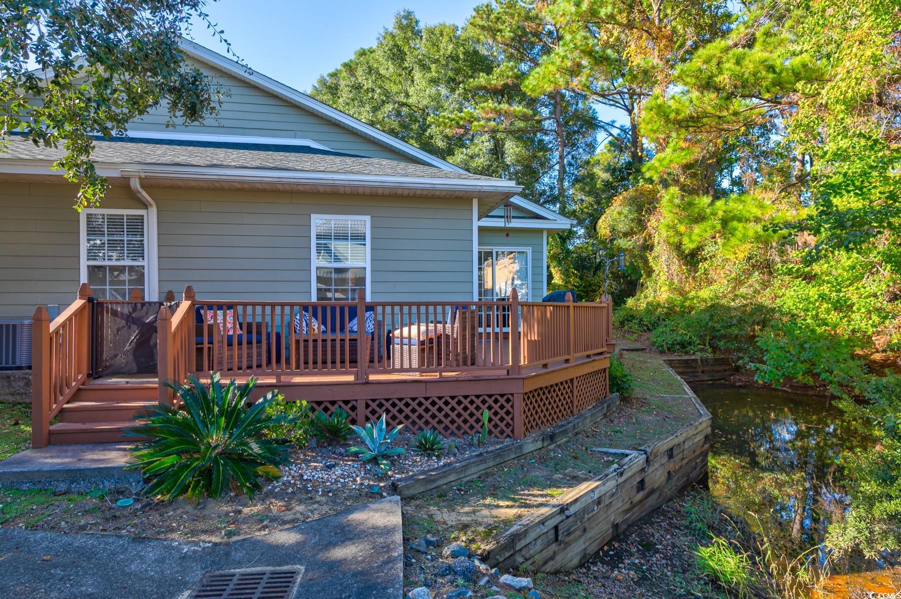 4840 Moss Creek Loop, Unit 36 Murrells Inlet, SC 29576 - Photo 34 of 37 Back of property featuring a deck and roof with shingles