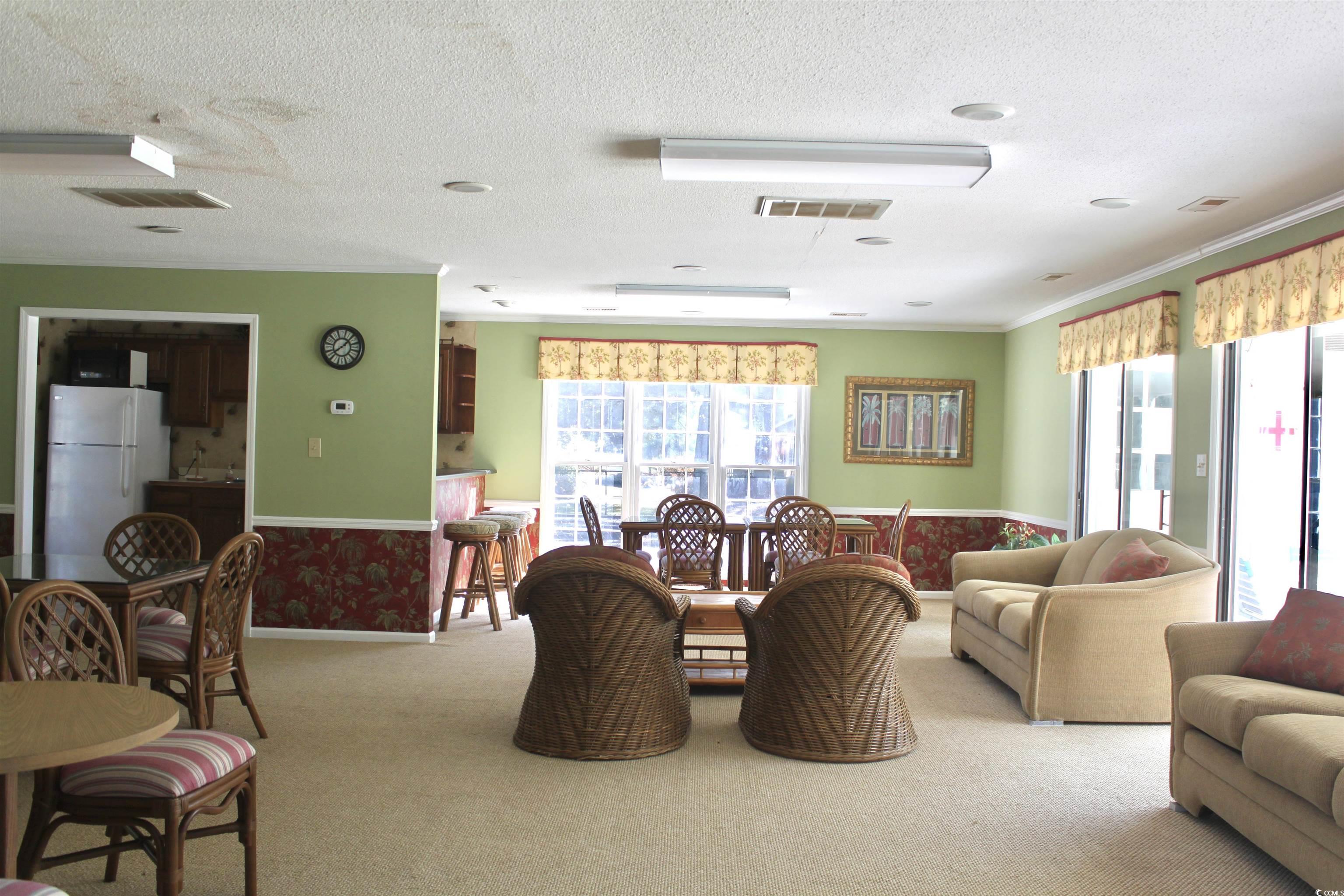 4840 Moss Creek Loop, Unit 36 Murrells Inlet, SC 29576 - Photo 36 of 37 Carpeted dining room with healthy amount of natural light, a textured ceiling, and wallpapered walls