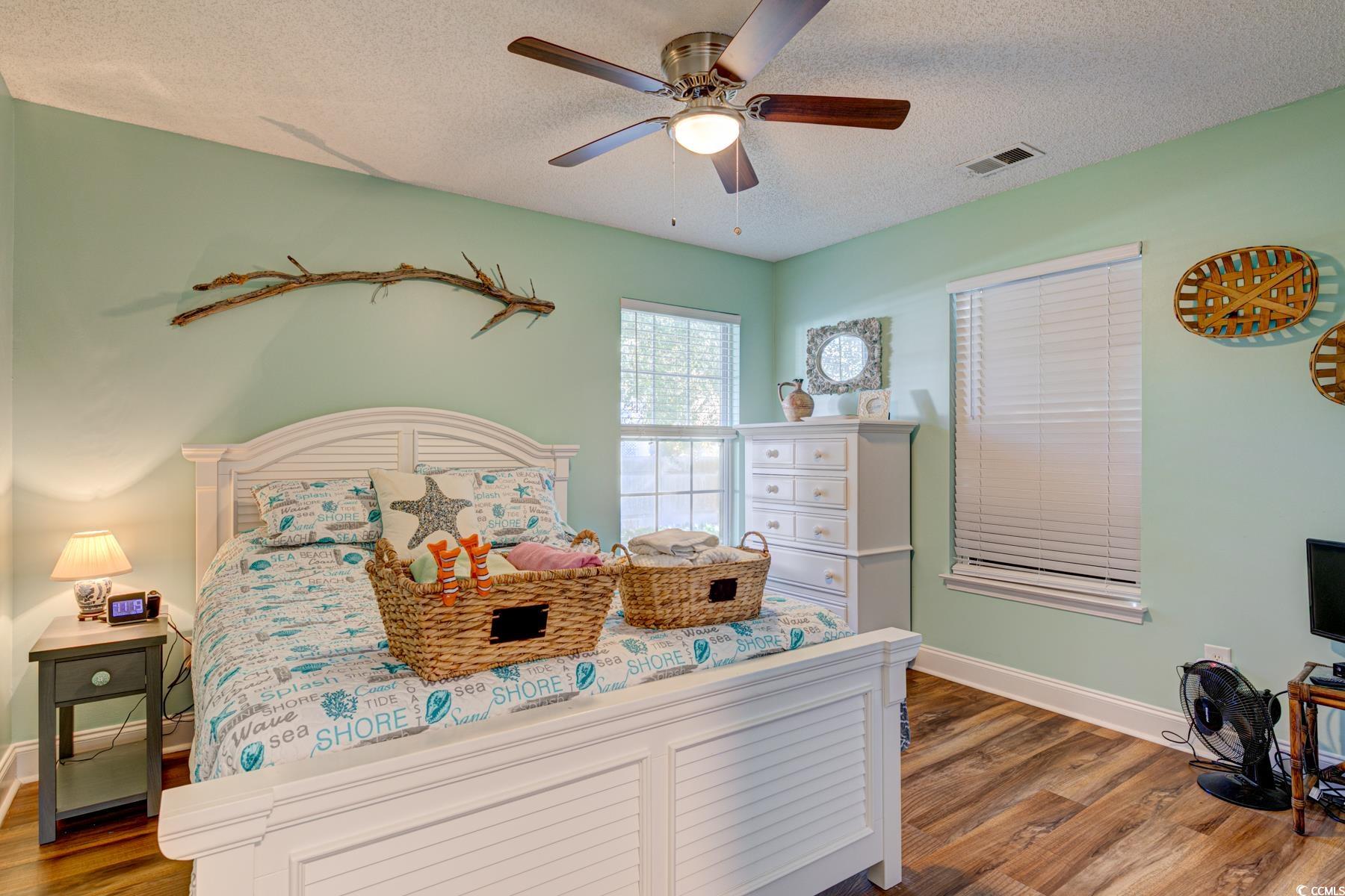 4840 Moss Creek Loop, Unit 36 Murrells Inlet, SC 29576 - Photo 4 of 37 Bedroom with a textured ceiling, dark wood finished floors, and ceiling fan